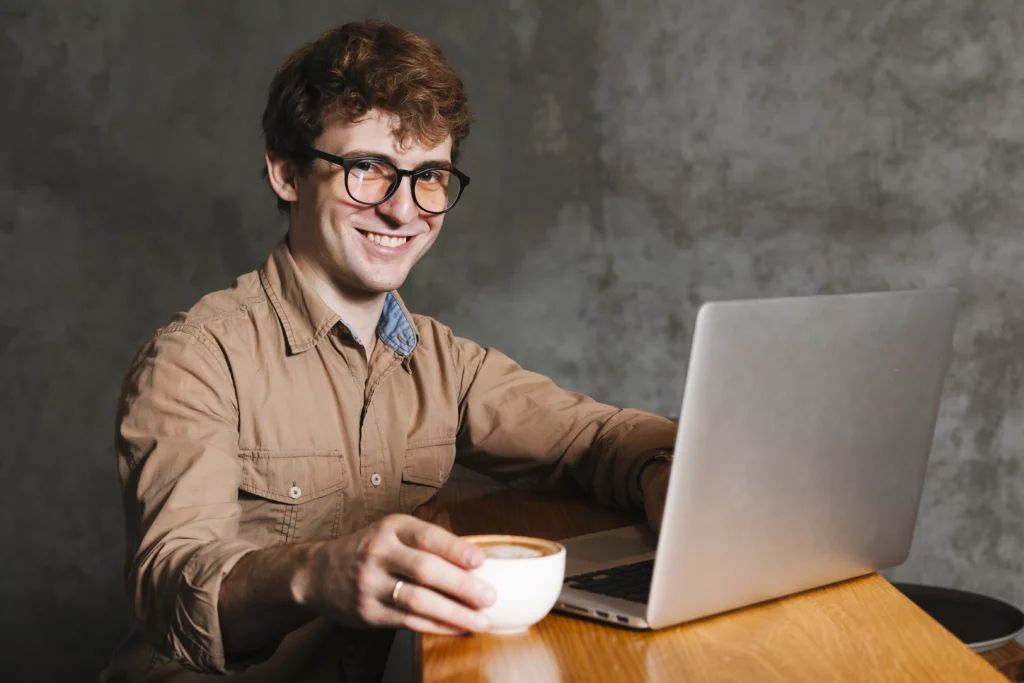 young-man-with-laptop-smiling
